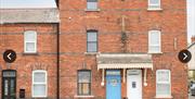 Front of house showing blue front door and all 3 storeys