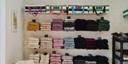 shelves at Bramble Green holding a range of colourful knitwear