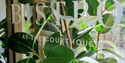 Glass door at entrance to the bistro. An etching on the glass reads 'Bistro at the Courthouse'