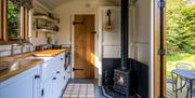 Hut interior showing kitchen and wood burning stove