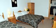 Image shows room with double and single bed