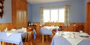 Dining room with 3 tables and 2 chairs to each table