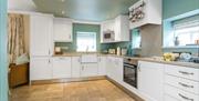 Large kitchen with a hob/oven, microwave and a Belfast sink.