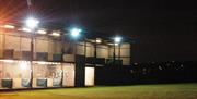 Photo of driving range lit at night