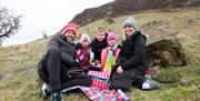 Family enjoying a picnic on Slemish at St Patrick's Day event