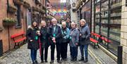 A group of DC Tour guests in Commercial Court, Belfast