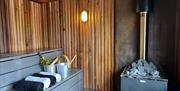 Inside of the sauna with towels and buckets of water