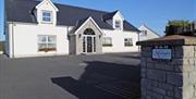 Outside photo of Kensington Lodge, white windows and black door