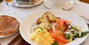 Breakfast plate with pancakes, wheaten bread, eggs and side salad