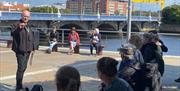 Lead guide Paul Donnelly taking a group of guests on a walking tour at Belfast Waterfront