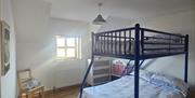 a double sized bunk bed in a bedroom at The Tangled Mermaid