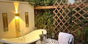 Outdoor cast iron cold bath with seating area