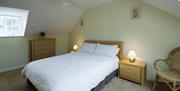 double room with bedside lockers and chest of drawers