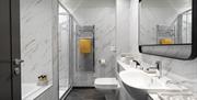 Bathroom with white ceramic sanitary ware and white marble effect tiling. Walk in shower and separate built-in bath. Mirror above sink with heated met