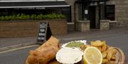 Fish and chips on a serving board