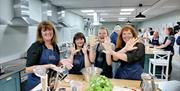 Image shows pupils cooking in the school kitchen