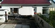 Outside view of Ronan Cottage with table and chairs