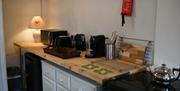 Kitchen area with white cabinets