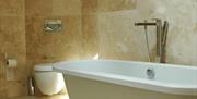 Bathroom with freestanding rolltop bath