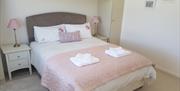 Double bedroom with bedside drawers and fresh towels.