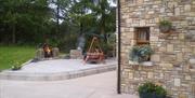 Outside patio area with firepit and wooden chair