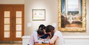 Children intensely focused on drawing during a workshop at the ulster museum