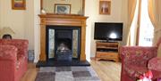 living room fireplace, armchairs and TV