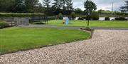 Outdoor space with slide, swings and trampoline