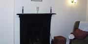 A seat beside a fireplace.