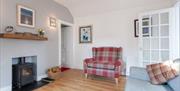 Living room with woodburner and two sofas