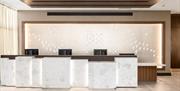 A brightly lit white reception area