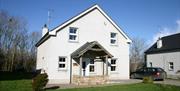 Large white two store house with stone porch feature