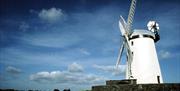 a side view photo of a windmill