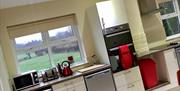 Picture of a cream kitchen with a microwave, toaster and kettle