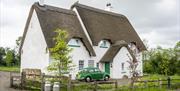 Outside view of Guest House with green car outside