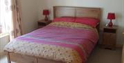 A double bedroom with two chests of bedside drawers.