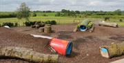 Outdoor play area with trees and tunnels