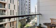 A balcony view of apartments with ground floor gardens.