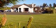 Outside view of house with large garden