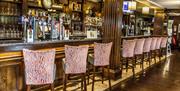 Image shows large bar area with lots of bar stools