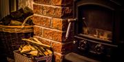 Wood burning stove in brickwork fireplace
