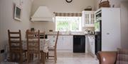 Kitchen and dining area with table and 5 chairs