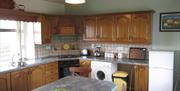 Kitchen with tiled backsplash and dining table