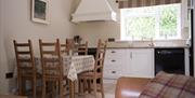 Kitchen and dining area with table and 5 chairs