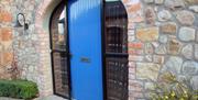 A bright blue door in an archway