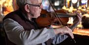 A gentleman playing a fiddle