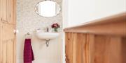 A bathroom with a sink and a mirror.