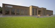 Photo of museum exterior and grassland to front