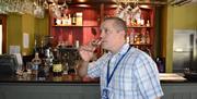 Mark from Ulster Whiskey Tours enjoys a glass of Whiskey