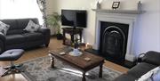 A living room with two sofas, TV, fireplace and coffee table